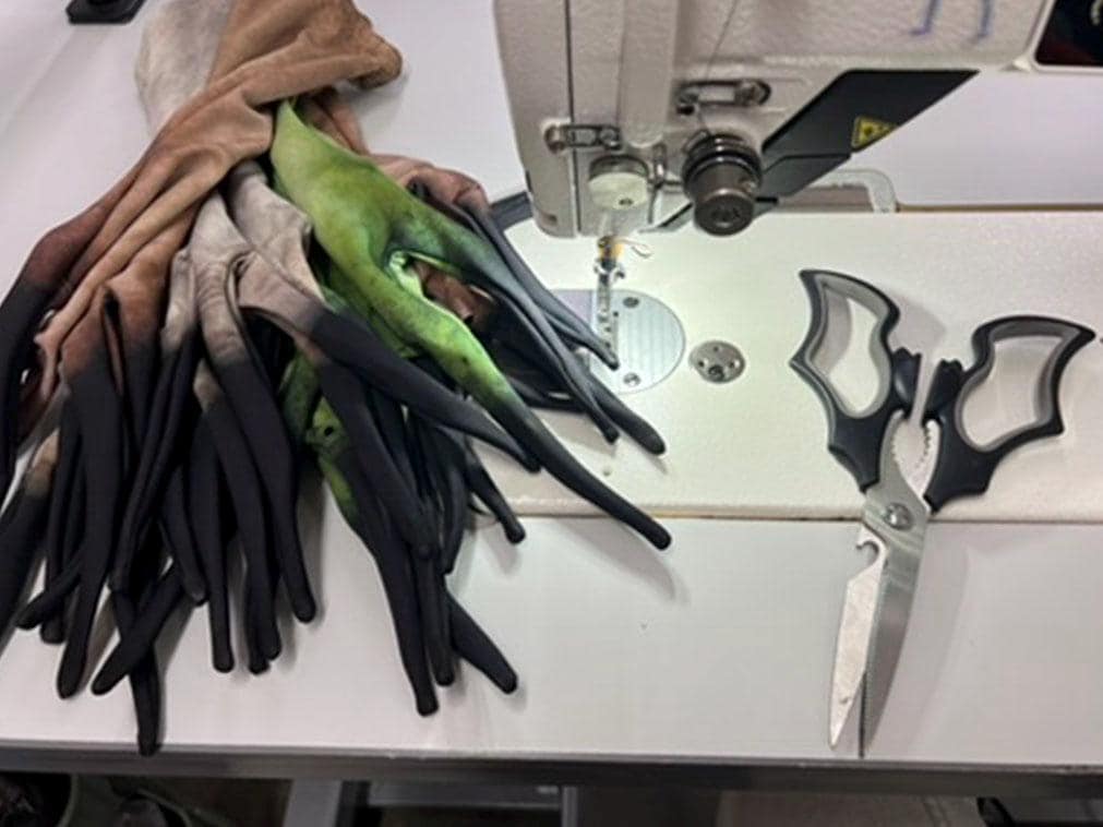 Long finger costume gloves being sewn in the ShapeShifterZ Los Angeles studio