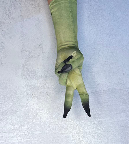 A single long green glove or sleeve worn on a hand, shown against a light textured background. The glove is olive green with two black-tipped fingers in an upside down peace sign. Palm  up