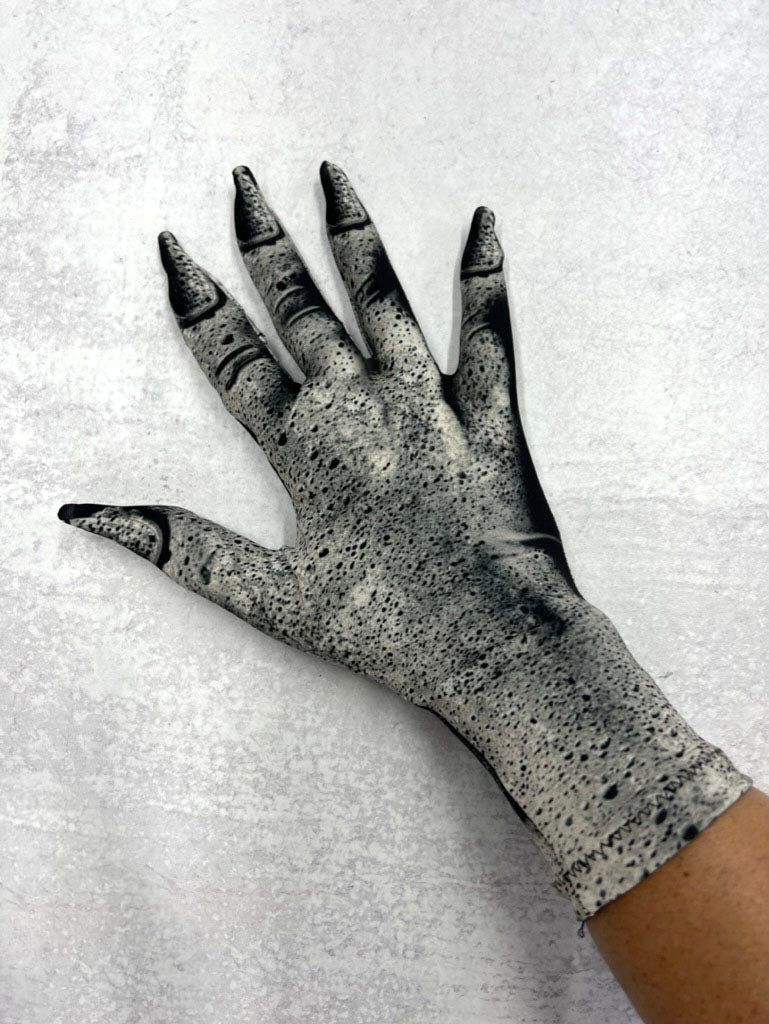 Black and white gargoyle stone glove on a live model