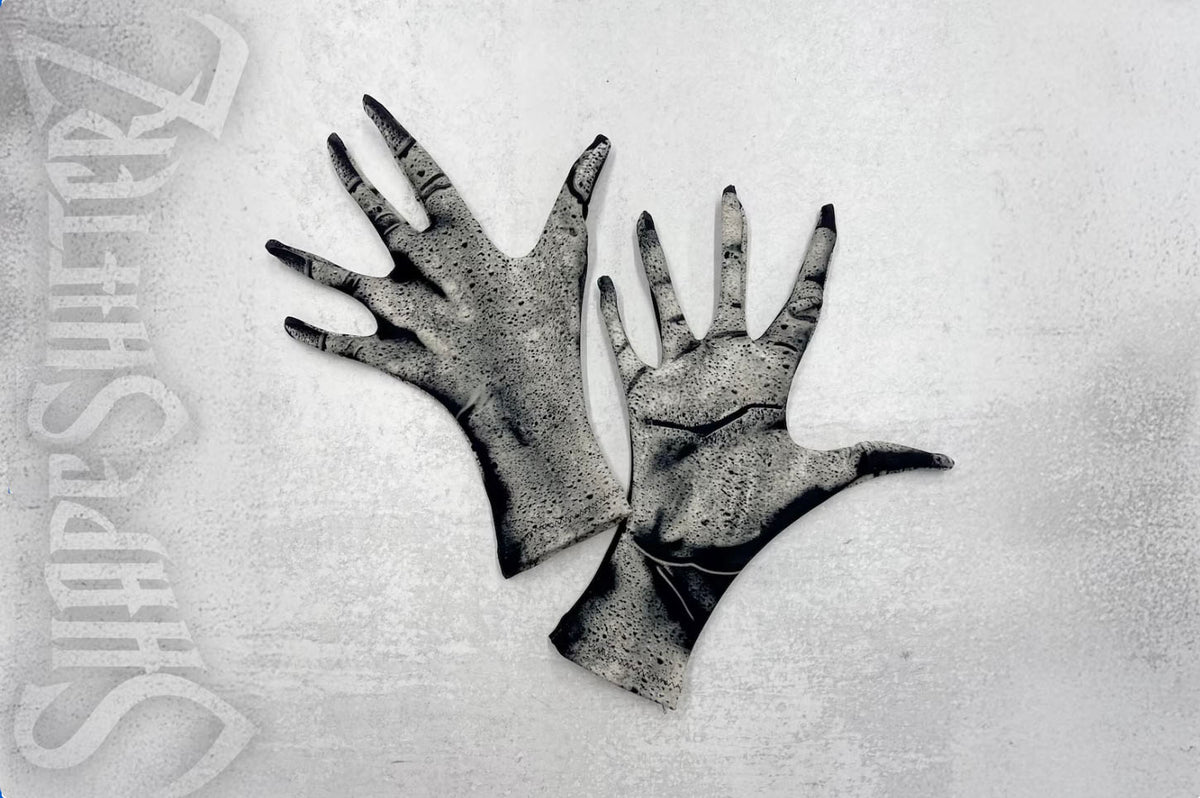 Black and white stone printed gloves, top of hand and palm view, on a textured surface with 'ShapeShifterZ' branding.