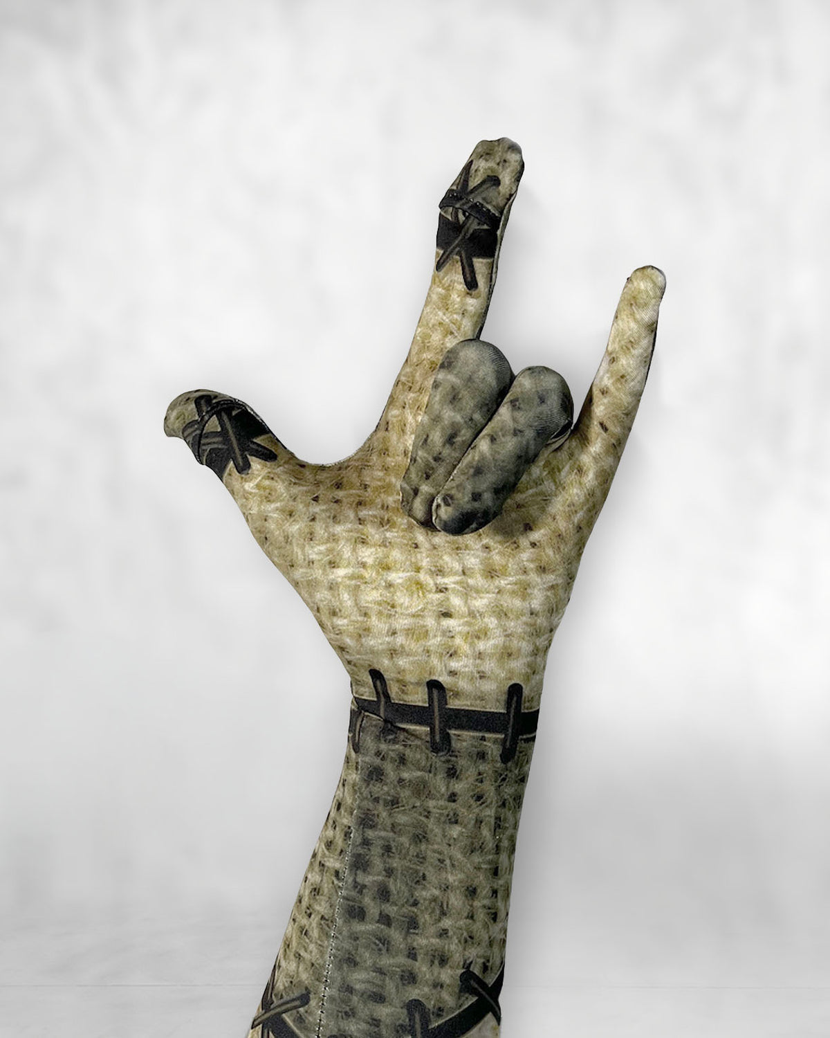 Burlap patchwork doll costume glove on a hand, stitch print detail